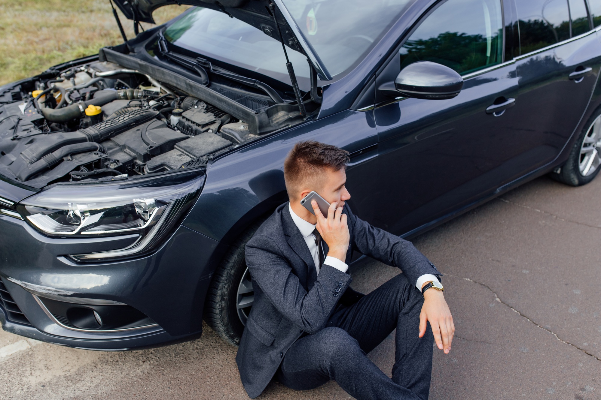 Businessman Calling for Roadside Assistance.
