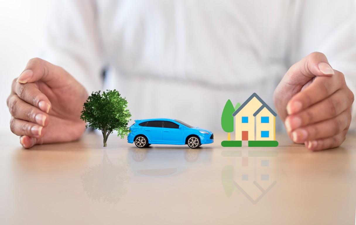 Car insurance, home cover and lifestyle protection with the hands of a broker covering your goods. .